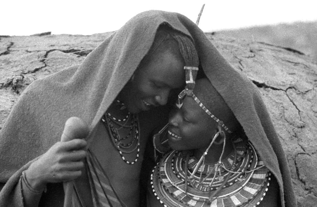 Maasai Lovers Flirt Under Blanket