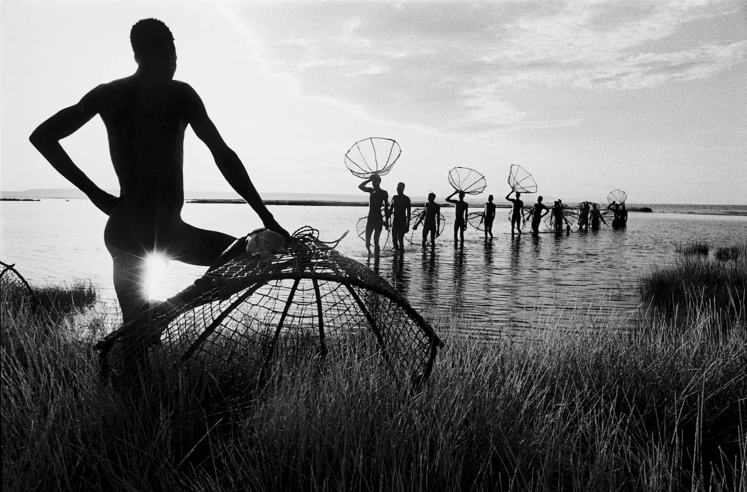 Fisherman Leaning on Fishing Basket in Lake Turkana